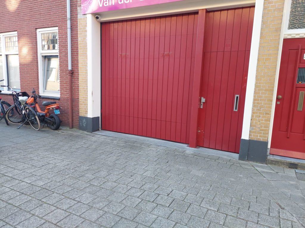 De oude situatie met de de houten sectionaaldeur en de oude houten loopdeur.